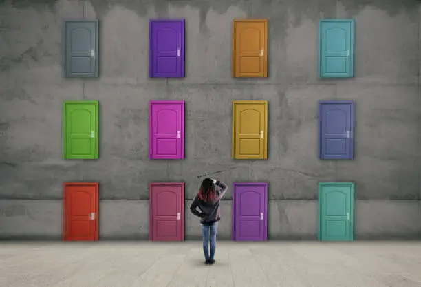 Photo of Multiple doors with different colors on a wall . Difficult decision concept .