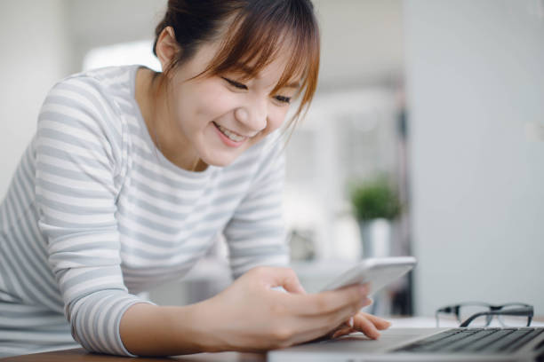 istock woman working with smart phone, business document and laptop computer notebook 1252823253