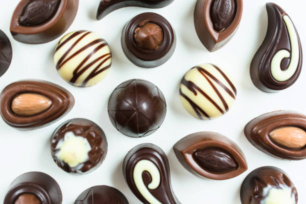 istock Background of different chocolates on a white background. Flat lay 1252824028