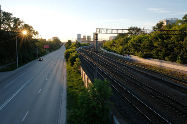 istock railroad and road at sunset 1252827012