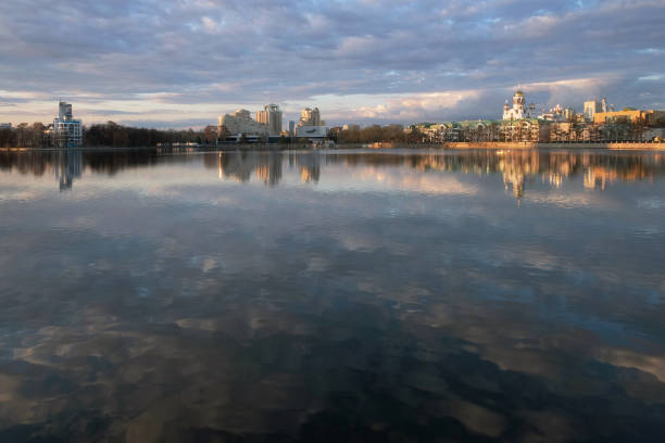 istock city reflected in a pond with clouds 1252827045