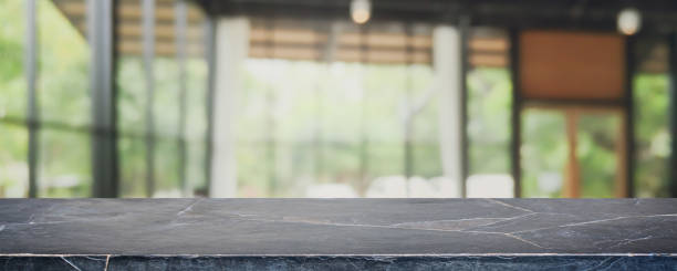istock Empty black marble stone table top and blurred coffee shop, cafe and restaurant interior background - can used for display or montage your products. 1252828155