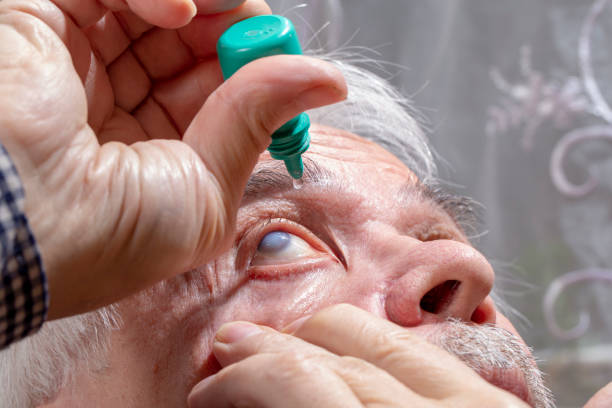 istock Elderly man buries medicine in his eyes 1252830569