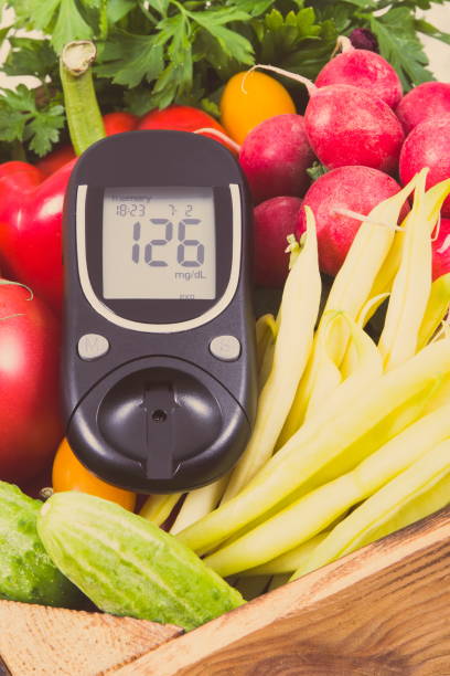 istock Glucometer for checking sugar level and vegetables as healthy ingredients containing vitamins using during diabetes 1252832945