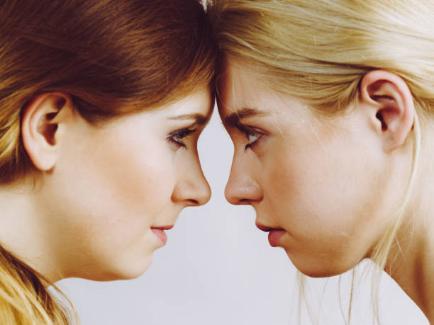 istock Two girls looking serious at each other. 1252835806