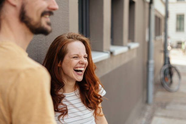 young woman laughing in amusement - mirth imagens e fotografias de stock