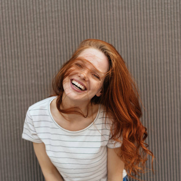 istock Happy young woman laughing happily 1252837636