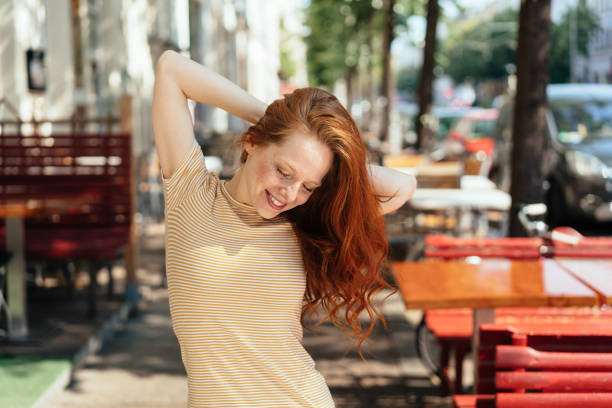 istock Pretty slender redhead woman smiling to herself 1252838225