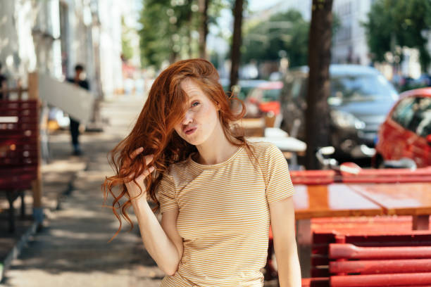 istock Young redhead woman pouting at the camera 1252838337
