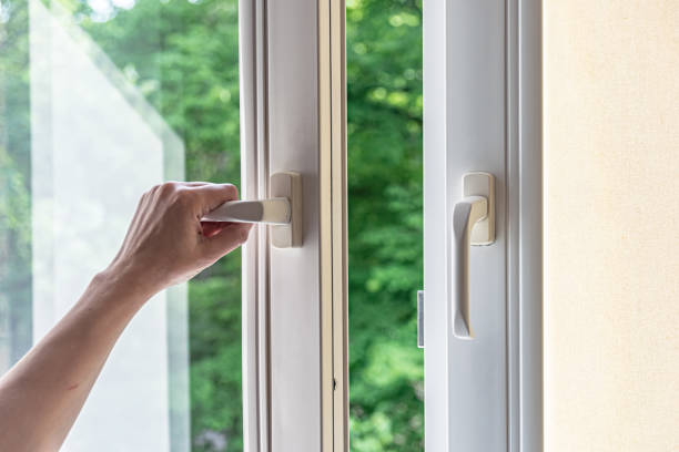 istock woman hand opens a plastic window for airing. Modern plastic windows. 1252838371