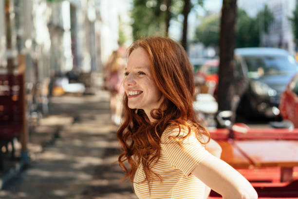 istock Smiling happy young woman outdoors in town 1252838422