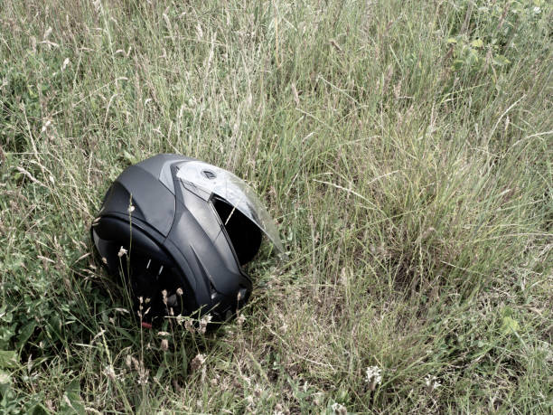 istock motorcycle helmet lies with open visor in the green grass 1252839315