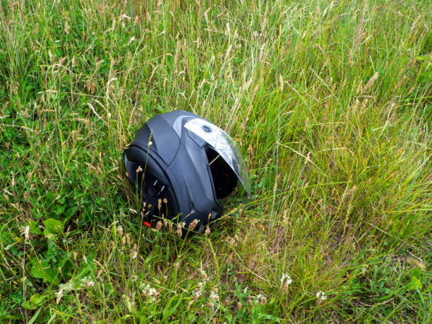 istock motorcycle helmet lies with open visor in the green grass 1252839317