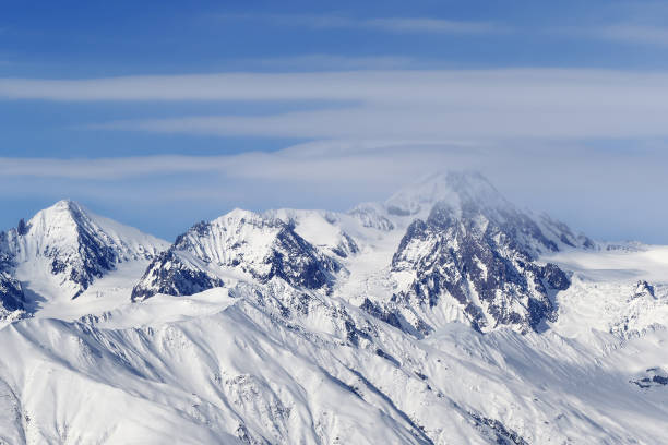 istock High snowy mountains and blue sky with clouds 1252839356