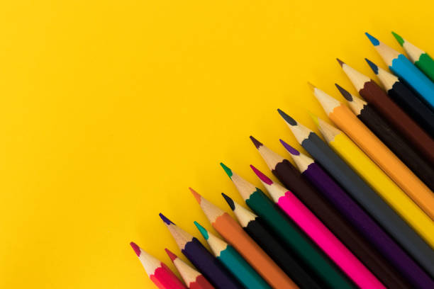 istock Colored pencils on yellow background with copy space.  Pencils on the corner. Back to school. Educational solution. 1252843267
