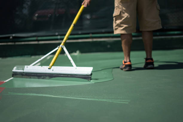 hard court is painting by worker