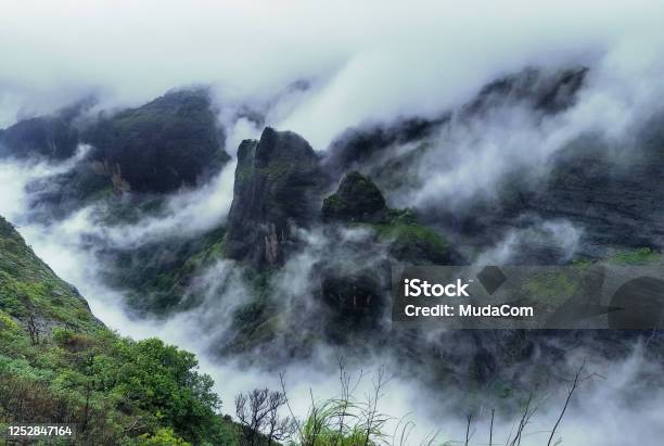 Mountain Cliff With Greenery And Clouds During Monsoon Season At Tamhini Ghat Viewpoint Maharashtra Western Ghats At The Start Of Monsoon Season Stock Photo - Download Image Now