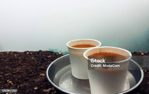 Steel Tray With Two White Paper Tea Cups Kept On The Wall During Monsoon On A Rainy Day In The Background Is The Valley Near Tamhini Ghat In Maharashtra Stock Photo - Download Image Now