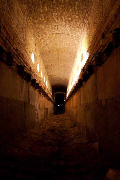 istock Old ruined brick vaulted tunnel. Dark passage. Underground communication 1252847658
