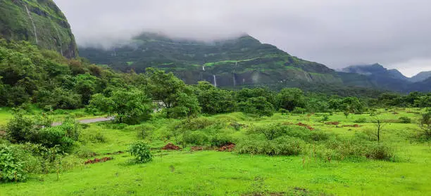Waterfalls flowing from scenic Western Ghats mountains of Tamhini near Pune Maharashtra during monsoon season. Perfect travel background. Monsoon magic landscape banner.