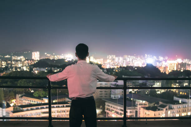 istock Businessman looking dreamlike city night 1252849502