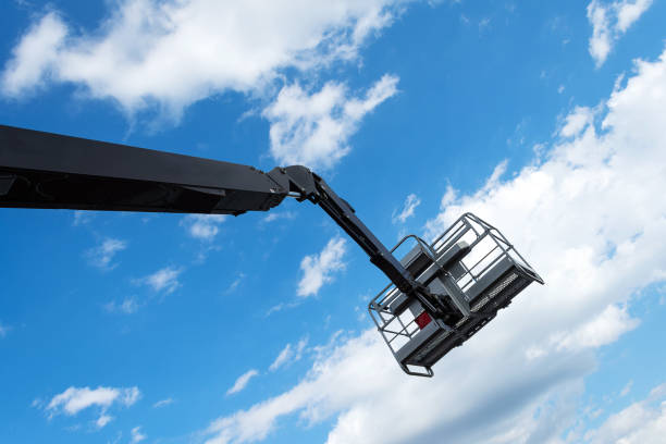 istock Hydraulic lifting platform with a bucket on a blue, cloudy sky. Building. Industry. Construction machinery. 1252850368