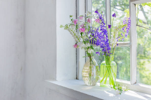 istock summer flowers in vase on windowsill in sunlight 1252851435