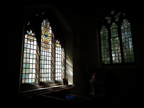 A stained glass window with sunlight coming through.