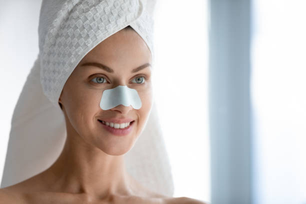 istock Millennial female using cleansing pores nose strips 1252855089