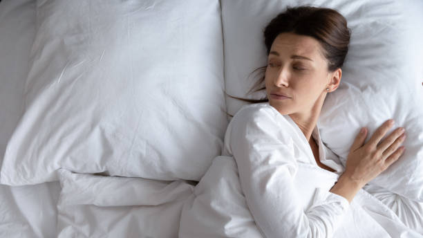 istock Sad young woman lying in bed feeling lonely 1252856153