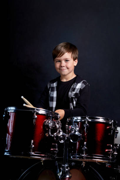istock Beautiful brunette boy is rehearsing before a performance. Blue background. 1252856320