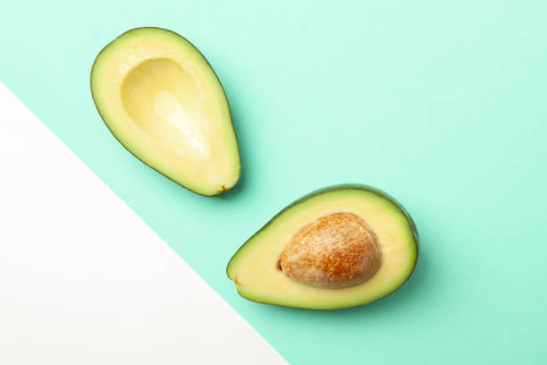 istock Ripe fresh avocado on two tone background, top view 1252856362