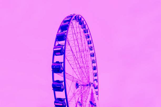 istock Orange ferris wheel on a bright yellow background 1252857309