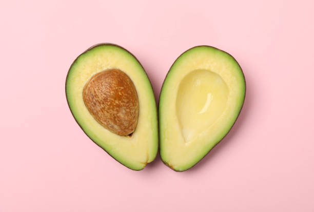 istock Ripe fresh avocado on pink background, top view 1252857441