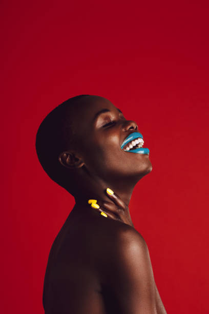 istock Smiling african woman with colorful makeup 1252858213