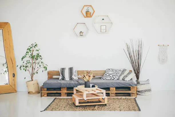 Cozy Living Room. Scandinavian Interior. Living room with pallet sofa and table.