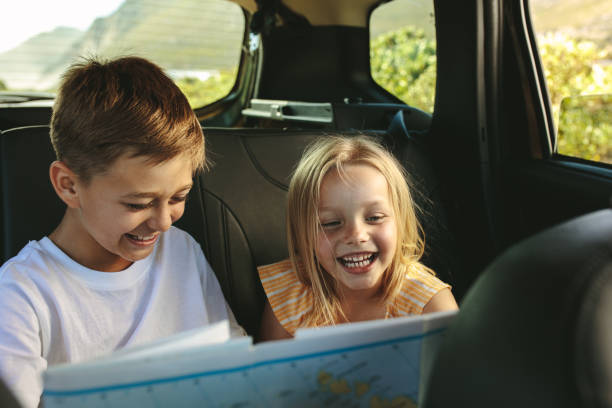istock Kids  playing with map in car 1252858591