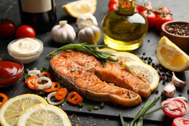 istock Composition with tasty grilled salmon on black background, close up 1252859220