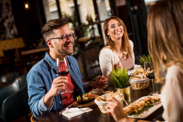 istock Group of young people having dinner in the restaurant 1252859473