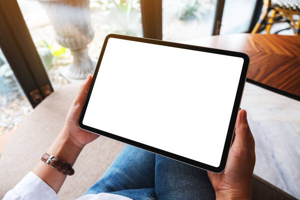 istock a woman holding black tablet pc with blank white desktop screen 1252859567