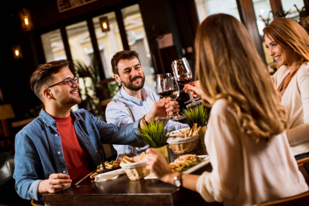 istock Group of young people having dinner in the restaurant 1252860634