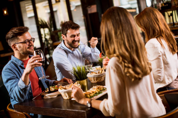 istock Group of young people having dinner in the restaurant 1252860638