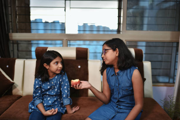 istock Elder Sister shares an apple 1252863126