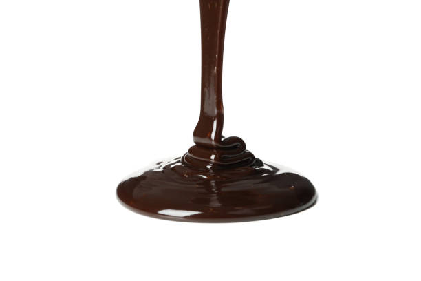 istock Melted chocolate is pouring, isolated on white background 1252863361