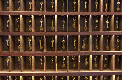 Retro keys in wooden storage, hotel reception, old vintage style, all keys in a place