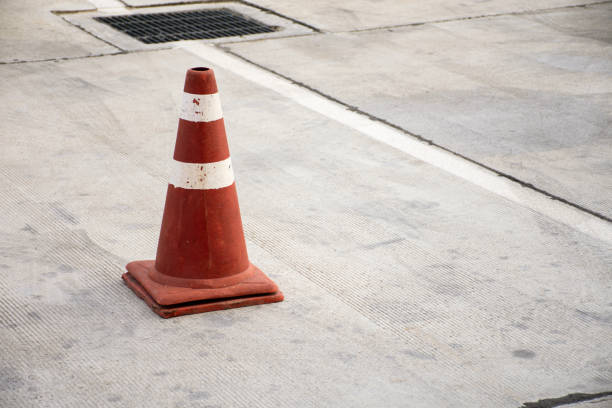 istock Old traffic cone on concrete road. 1252865510