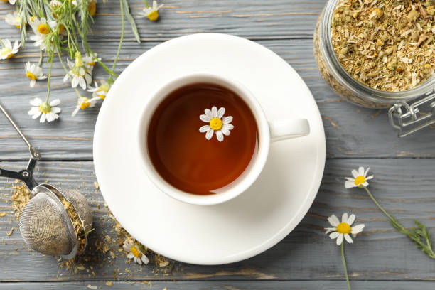 istock Composition with cup of chamomile tea on grey wooden background 1252866376