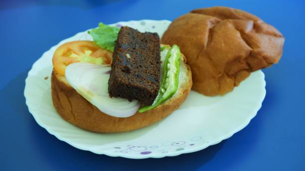 istock stuffed big burger on white plate and blue background 1252866659