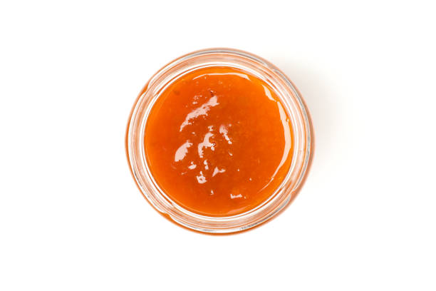 istock Glass jar with apricot jam isolated on white background 1252868990