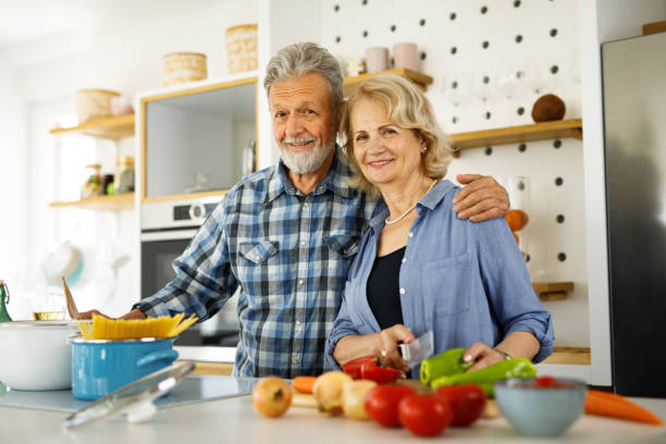 istock Cute elderly couple preparing family dinner in the kitchen 1252870156